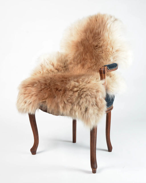 A warm sandy beige natural sheepskin rug