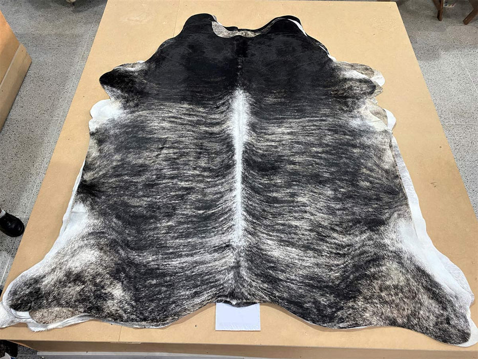 A beautiful dark sand and black exotic stripe cowhide rug