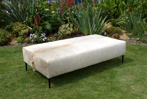 Large cowhide ottoman with black legs