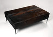 Dark cowhide ottoman black metal legs