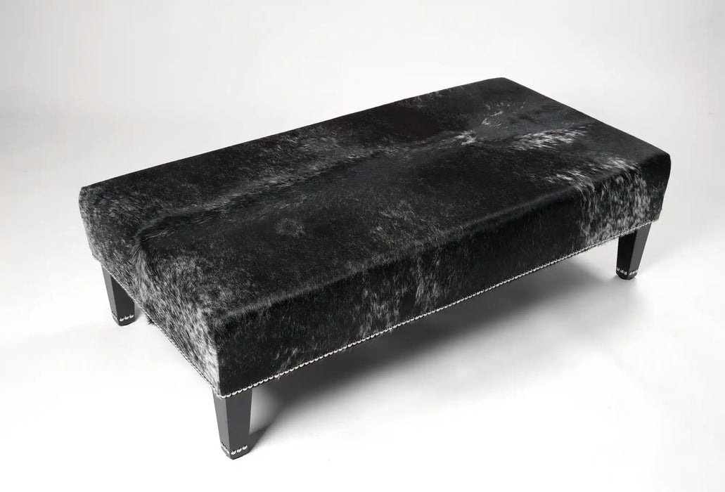 Dark grey salt n pepper speckle cowhide ottoman with decorative studs