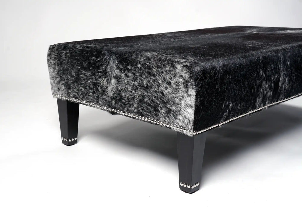 cowhide ottoman leg detail with decorative studs