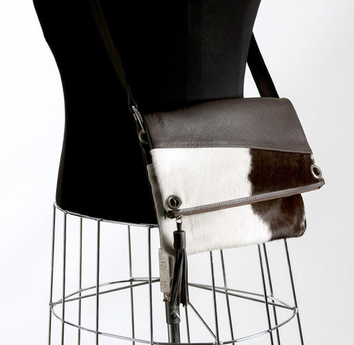 Brown and white cowhide handbag